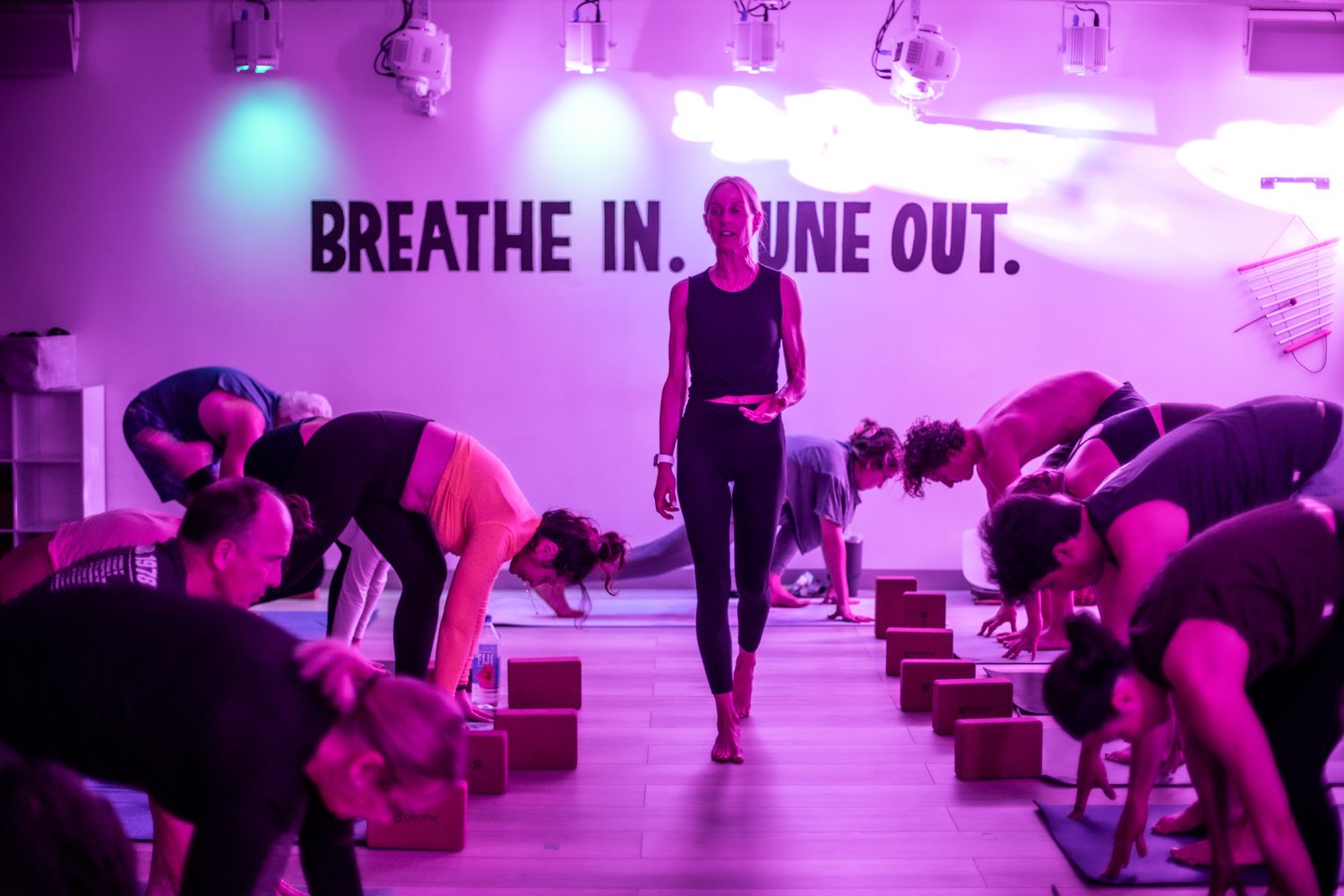 Yoga instructor giving a yoga class at breathe degrees