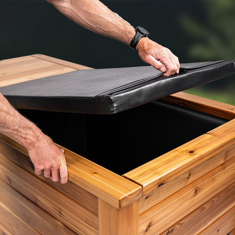 Image of a man opening the insulated top of the breathe degrees cold plunge tub